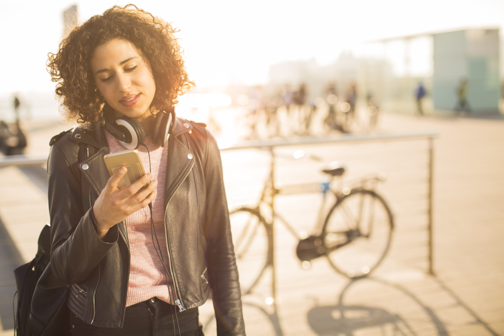 Beautiful young woman texting on her smart phone.
