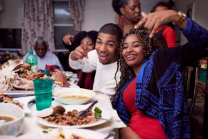 Brother and sister posing at dinner table