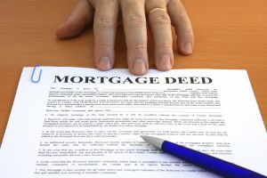Male hand presents a mortgage document
