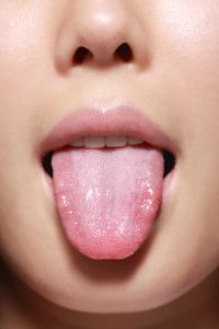 Tongue of young woman,close-up